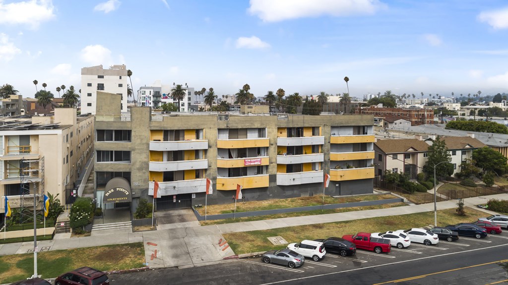 A parking lot with cars and a building in the background.