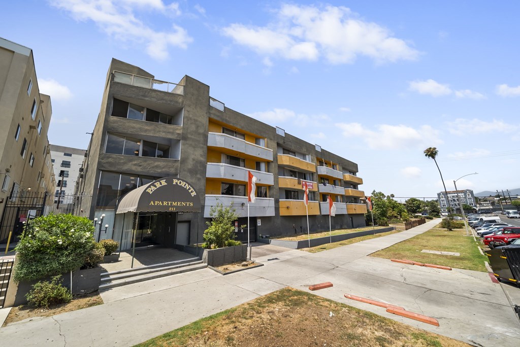 A large apartment complex with a sign that says "Apartments" on the front.