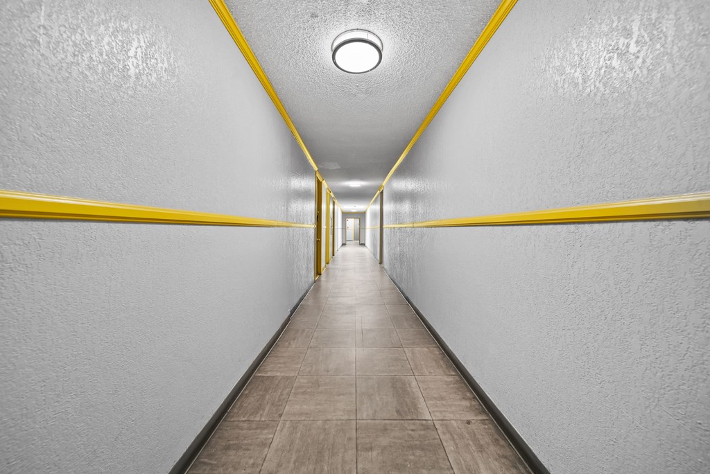 A long hallway with yellow lines on the walls.