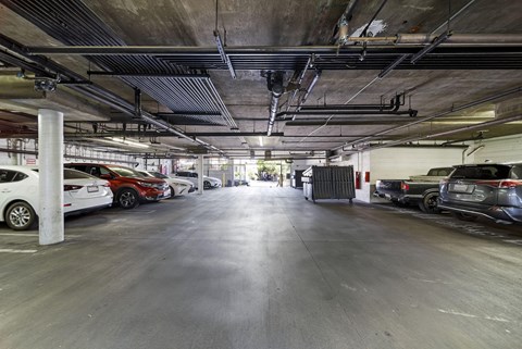 A spacious parking garage with multiple cars parked.