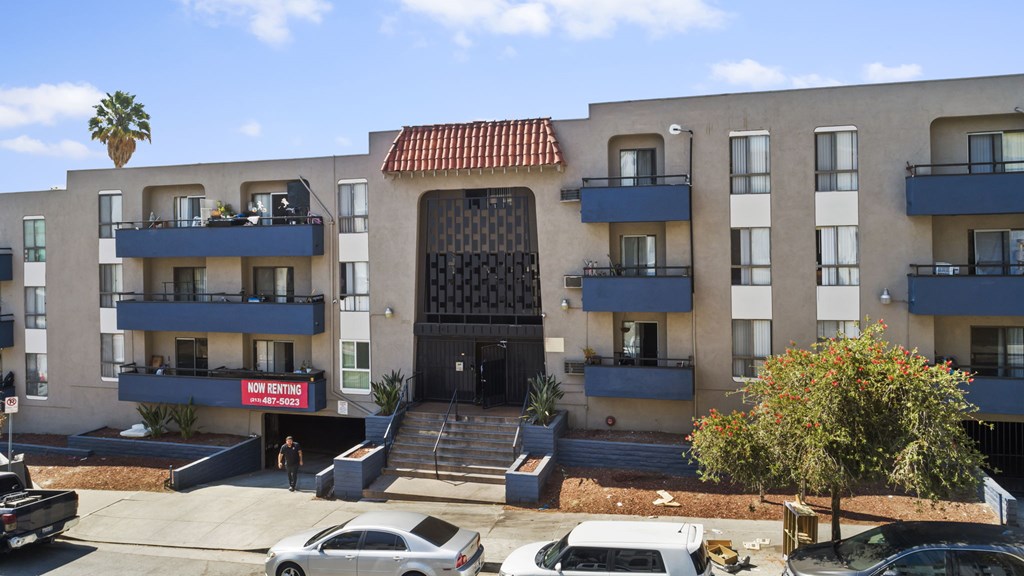 A building with a red sign that says "No Parking" in front of it.