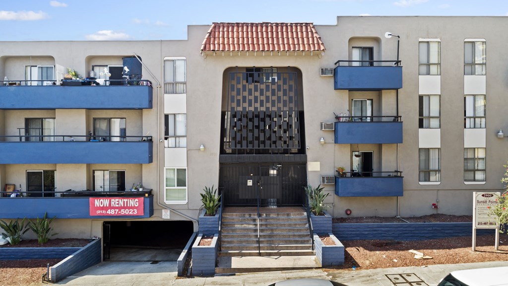 A building with a black gate and a sign that says "NO RENTING" in front of it.