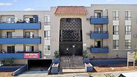 A building with a black gate and a sign that says "NO RENTING" in front of it.