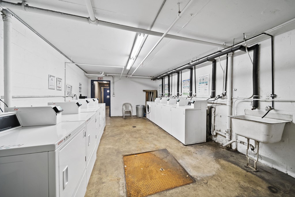 A large industrial room with white walls and a yellow mat on the floor.