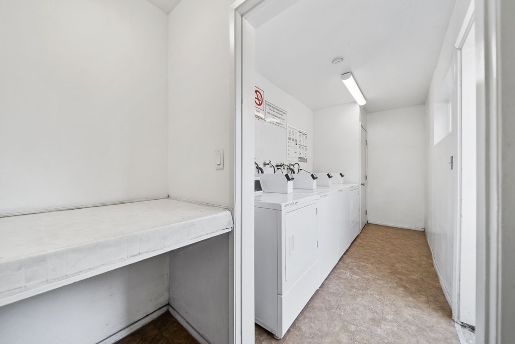 A white laundry room with a washer and dryer.