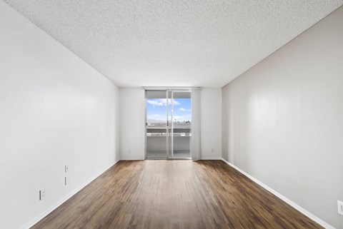 A room with wooden floors and white walls.
