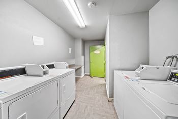 A row of white copiers in a clean, empty room.