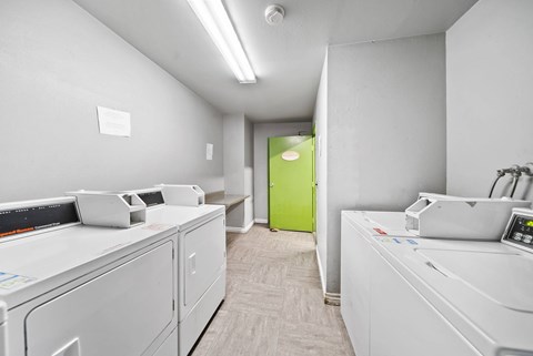 A row of white copiers in a clean, empty room.