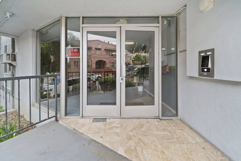 A glass door with a red sign on it.