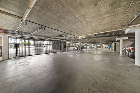A large, empty parking garage with a concrete floor and ceiling.