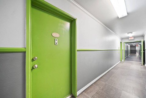A green door with a number 130 on it.