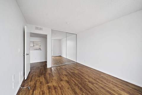 A room with a wooden floor and white walls.