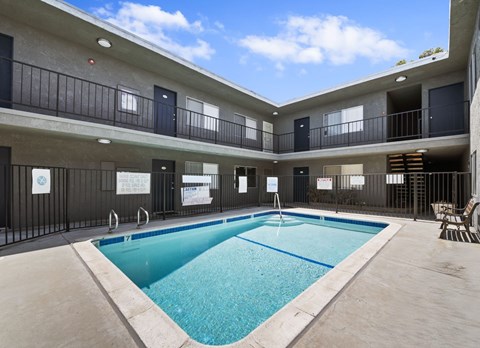 A large indoor swimming pool in a building with balconies.