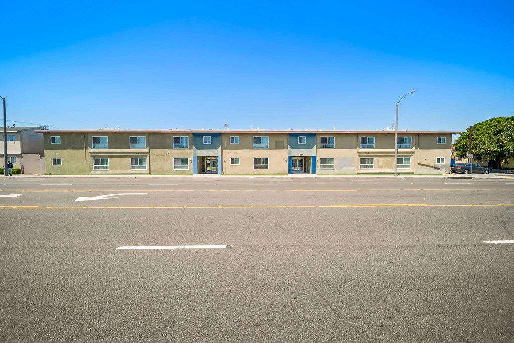 A row of apartment buildings with a clear blue sky above.