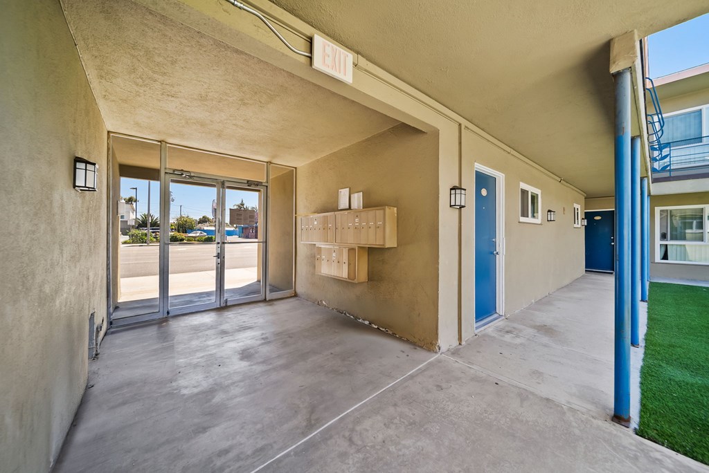 A concrete covered balcony with boxes on it.