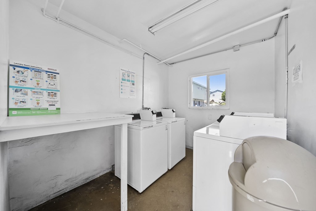 A white laundry room with a washer and dryer.