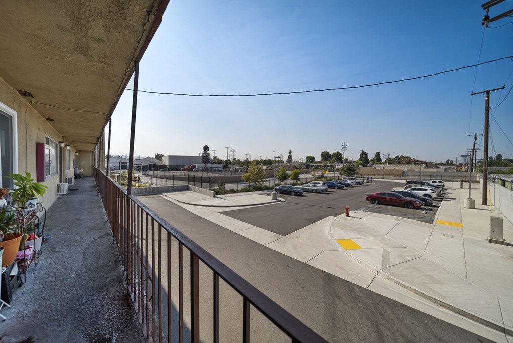 A parking lot with cars and a building in the background.