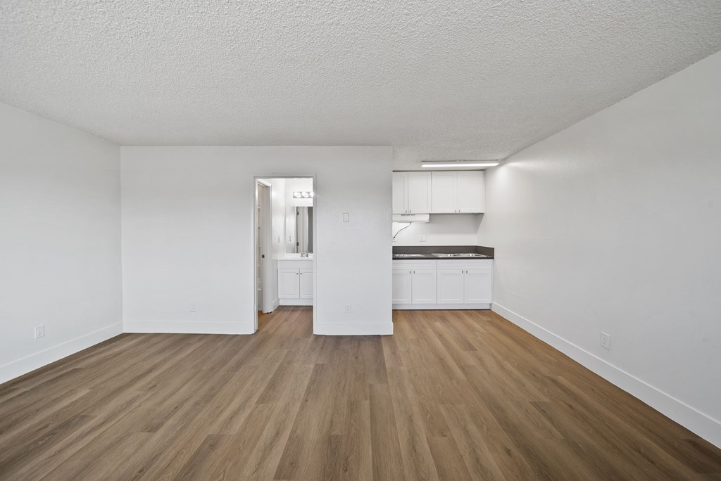 A room with wooden floors and white walls.