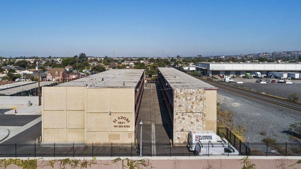 A white van is parked in front of a building with a sign that reads "ADAMS".