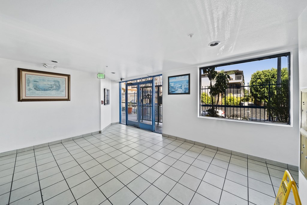 A room with a tiled floor and a painting on the wall.