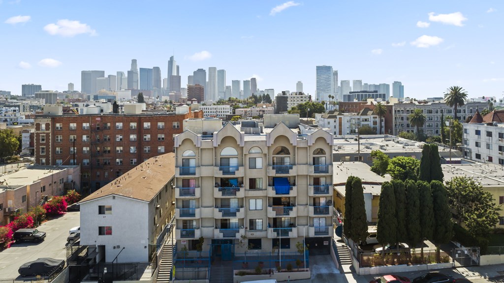 A building with a balcony in front of a city skyline.
