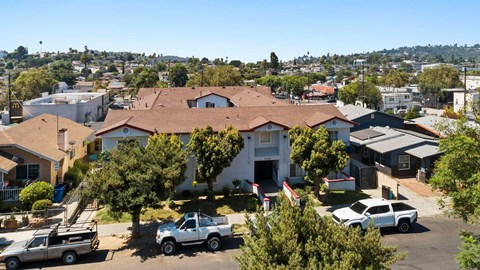 A white truck is parked in front of a house.