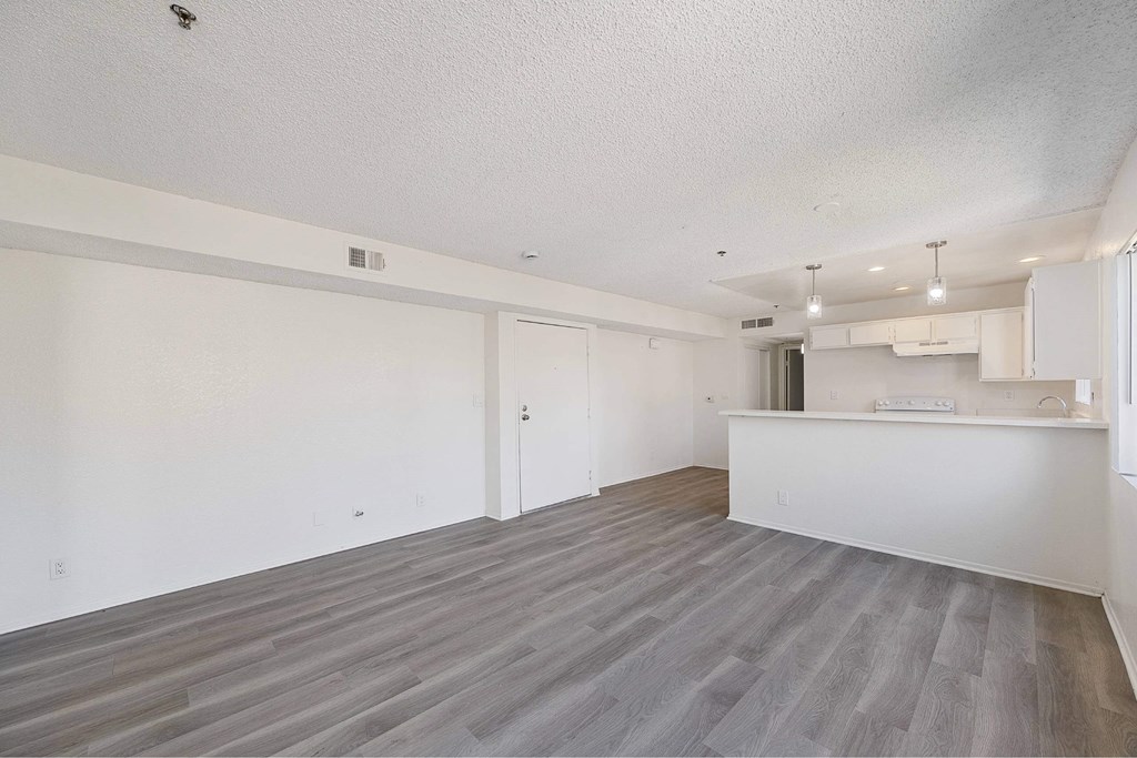 A spacious room with a grey floor and white walls.