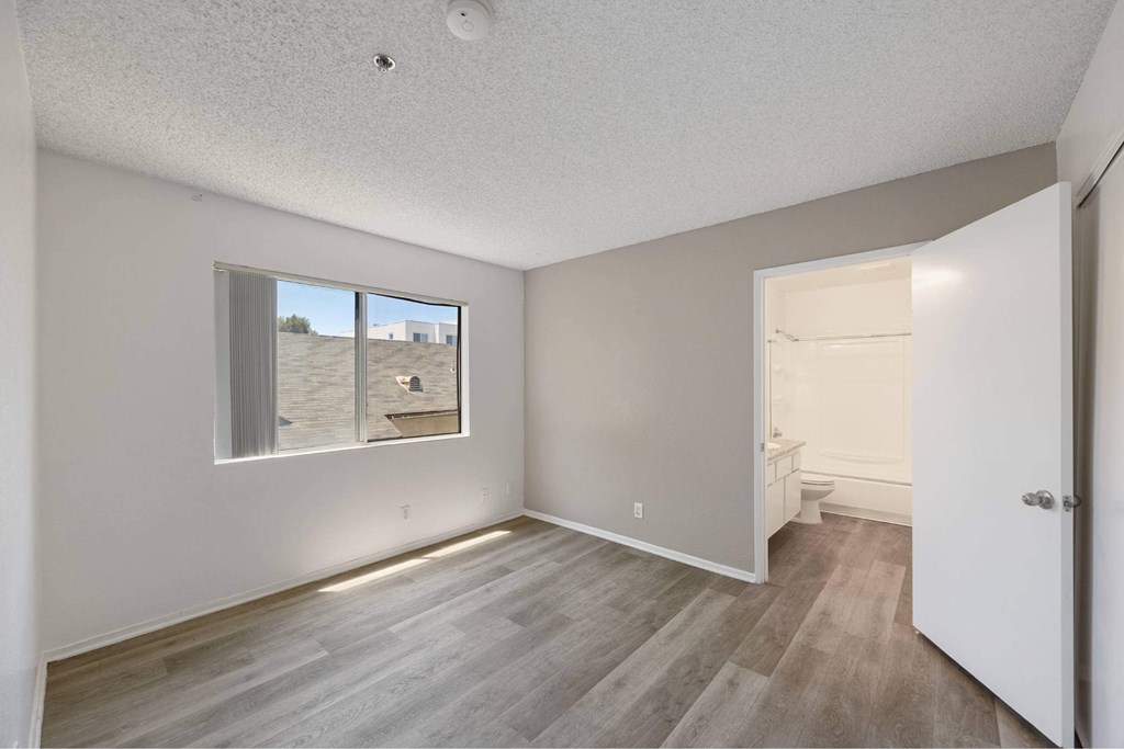 A room with a window and a door.