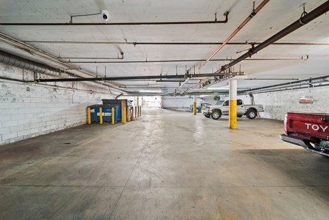A Toyota truck is parked in a large, empty parking garage.