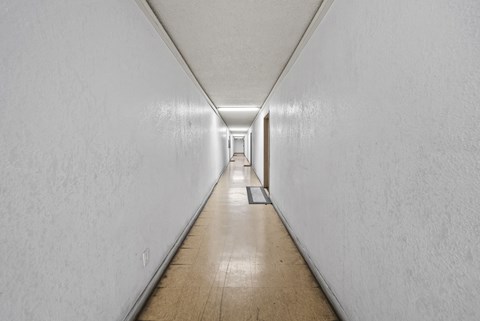 A long hallway with a door at the end.