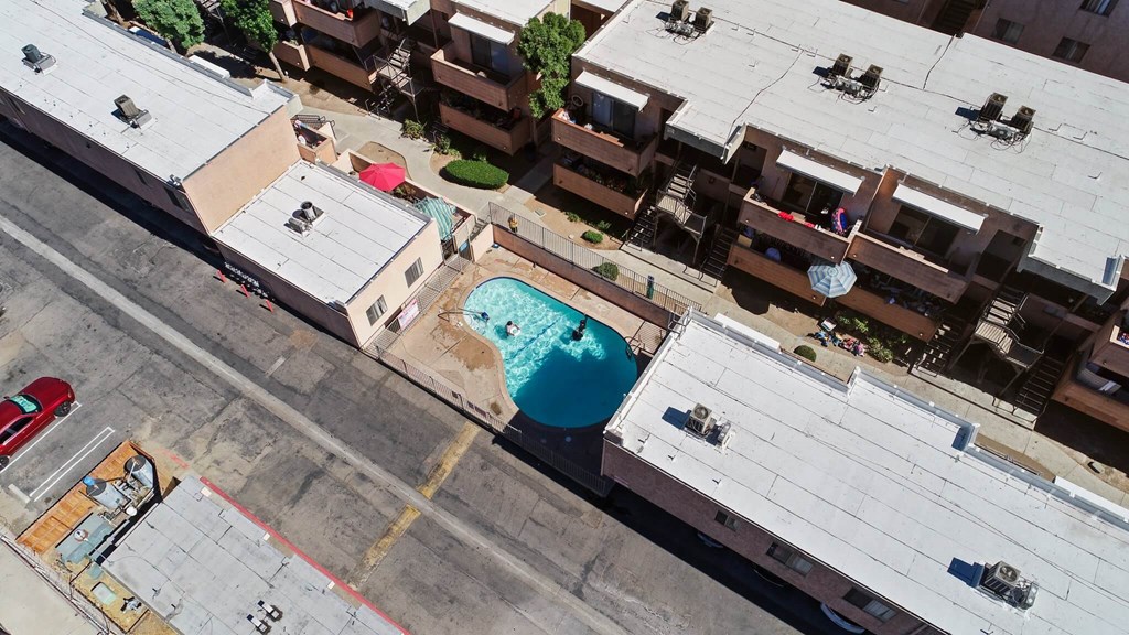 A red car is parked on the side of a road.