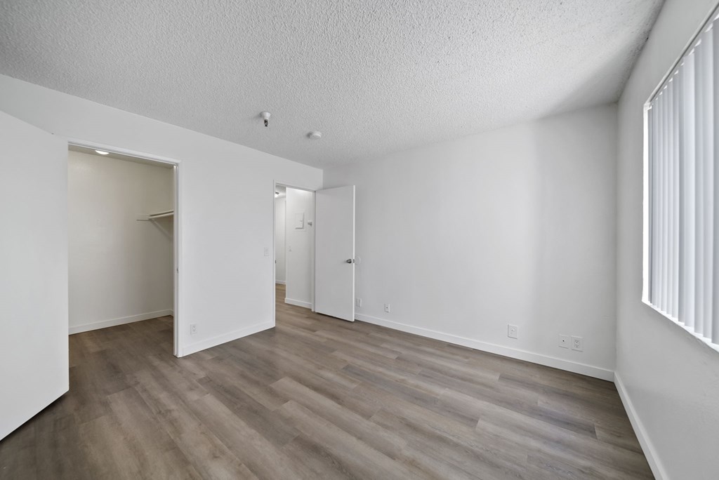 A room with wooden floors and white walls.