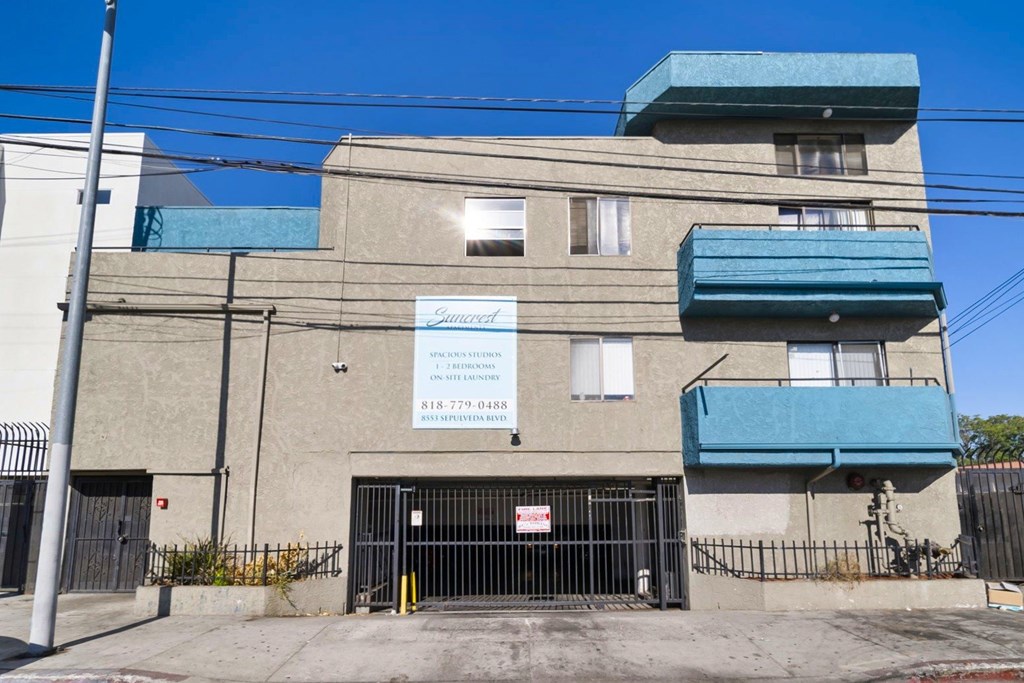 A building with a sign that says "Sunset" on it.