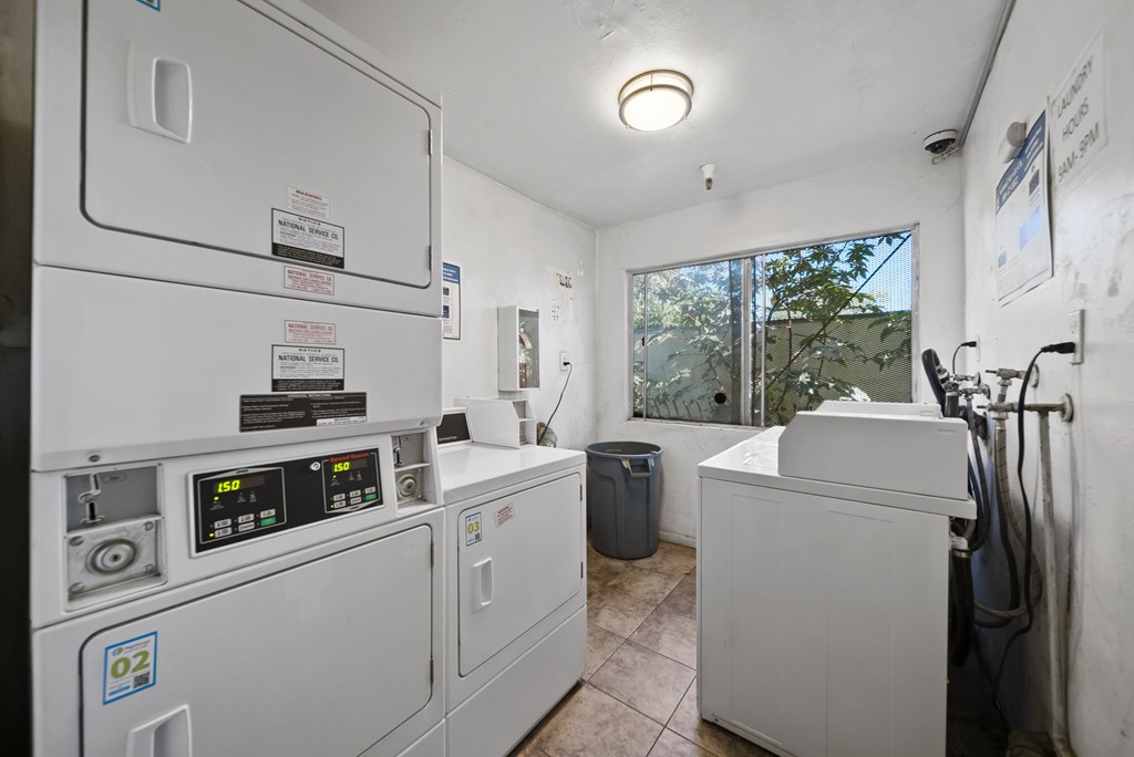 A room with a washing machine and a dryer.