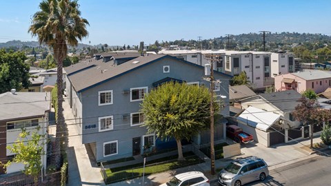 A residential area with houses and parked cars.