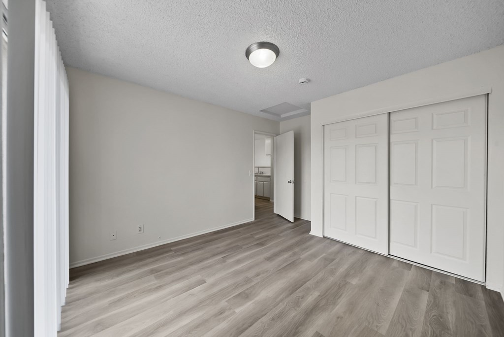 A room with a white ceiling and a wooden floor.