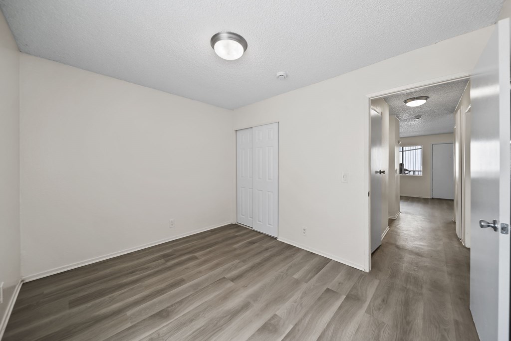 A room with a white door and a white wall.