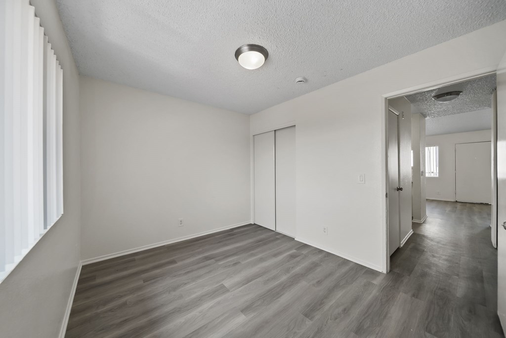 A room with a wooden floor and white walls.