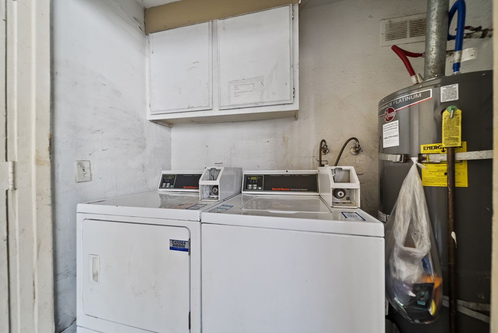 A white washing machine and dryer in a laundry room.