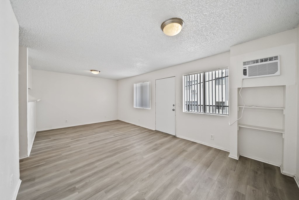 A room with a wooden floor and white walls.