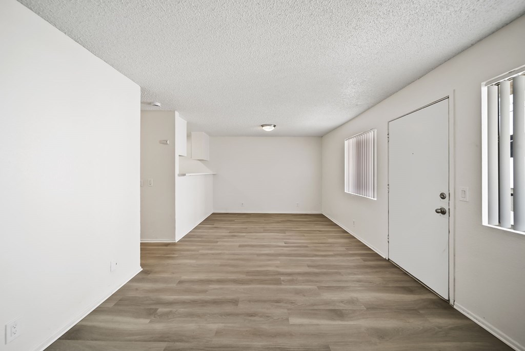 A room with a wooden floor and white walls.