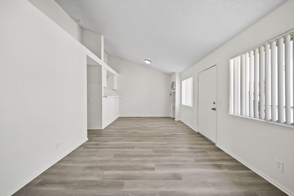 A room with white walls and a grey floor.