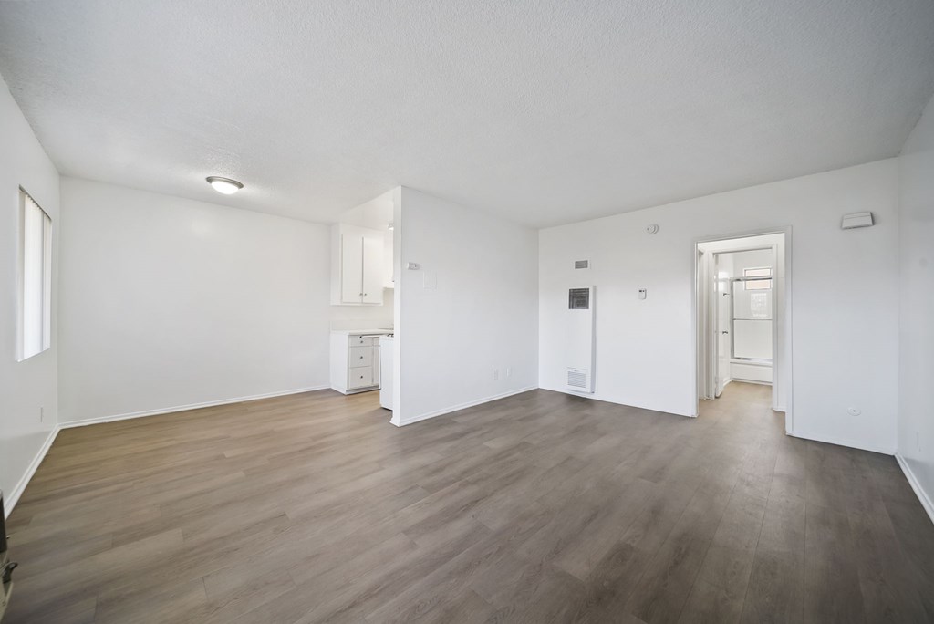 A room with wooden floors and white walls.