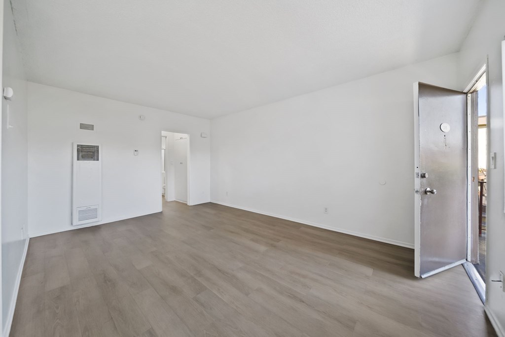 A room with a wooden floor and white walls.