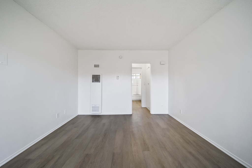A room with white walls and wood flooring.