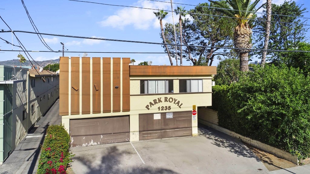 A building with a brown and beige facade is labeled "Park Royal 1235.".