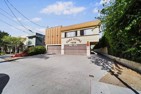 A building with a brown and beige facade has a sign that reads "Fair Royal 1236.".