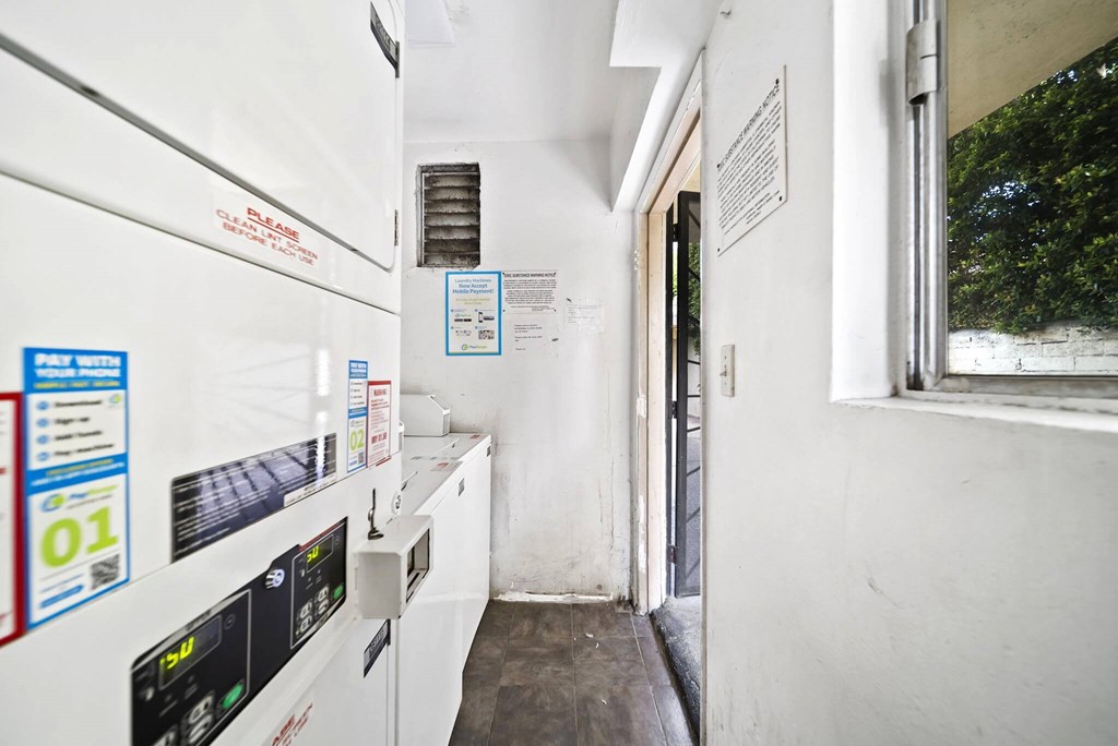 A white industrial machine with a black screen and blue and red labels.