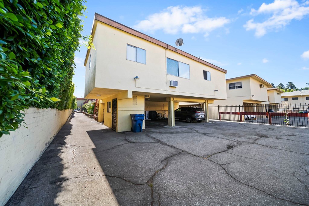 A two-story building with a parking lot in front.