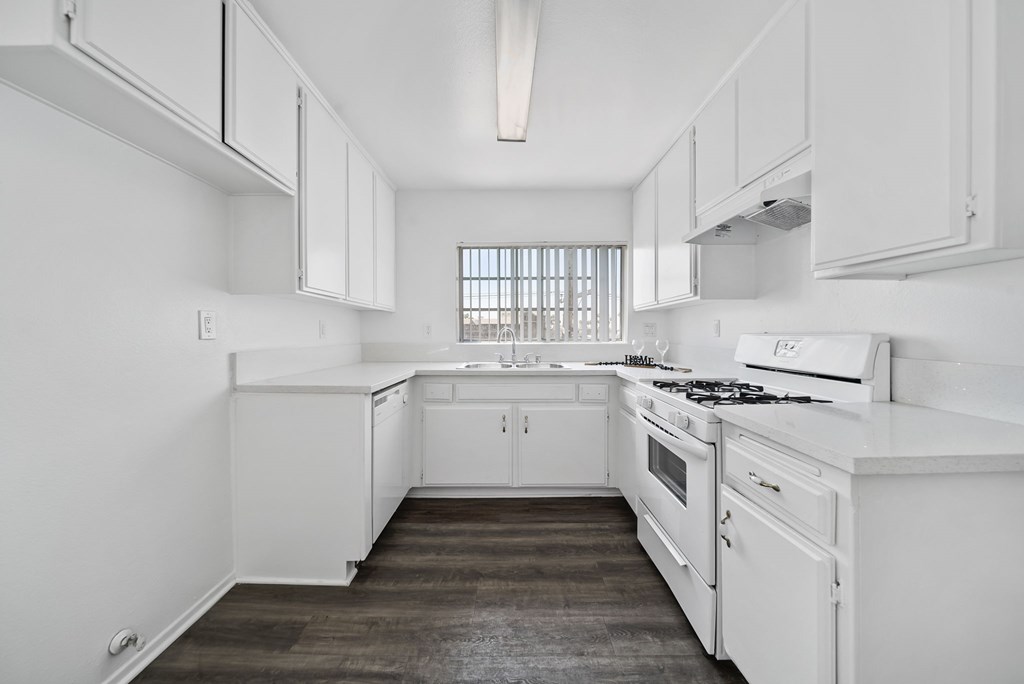 A white kitchen with a window.